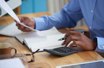 Close-up image of financial managers working with reports